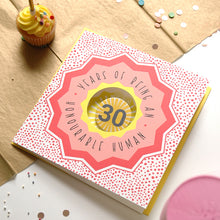 Load image into Gallery viewer, Card with '30 Years of Being an Honourable Human' text on a polka dot background, with a cupcake and confetti in the background.
