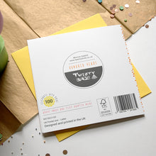 Load image into Gallery viewer, Card with branding and product details on a surface with confetti