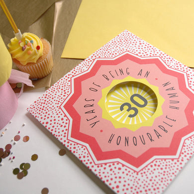 Card with '30 Years of Being an Honourable Human' text on a festive background with confetti and a cupcake.