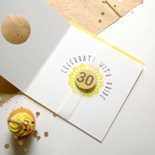 Load image into Gallery viewer, Greeting card with &#39;Celebrate with Pride&#39; and number 30 design, next to a cupcake on a light background.