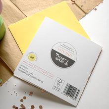 Load image into Gallery viewer, Back of a card with branding and text on a wooden surface