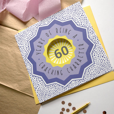 60th birthday card with decorative elements on a light background