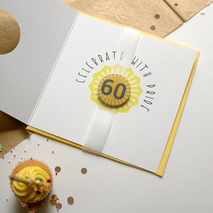 Greeting card with 'Celebrate with Pride' and number 60 design, surrounded by confetti and a cupcake.