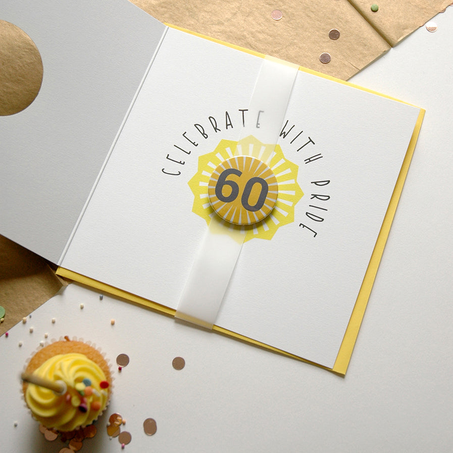 Greeting card with 'Celebrate with Pride' and number 60 design, surrounded by confetti and a cupcake.