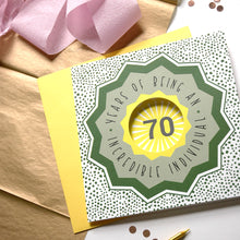 Load image into Gallery viewer, 70th birthday card with decorative elements on a wooden surface