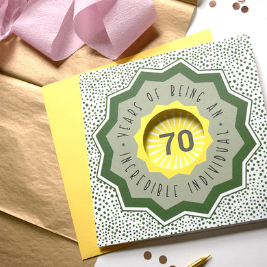 70th birthday card with decorative elements on a wooden surface