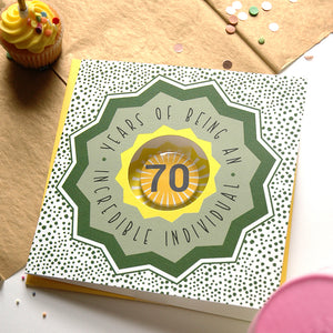 70th birthday card with decorative elements on a table