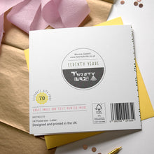 Load image into Gallery viewer, back of card with branding and product details on a wooden surface
