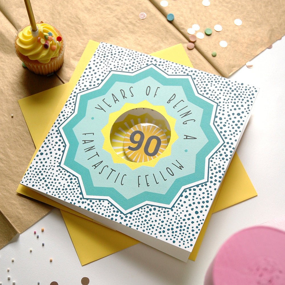 90th birthday card with decorative elements on a table with a cupcake.
