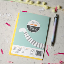 Load image into Gallery viewer, A mint green and yellow 'Twenty Birds' greetings card back, including a yellow envelope, styled on a light marble surface with a pastel pen, confetti, and decorative elements.