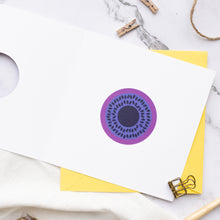 Load image into Gallery viewer, Purple circular centre of anemone on a white card with yellow envelope on marble surface.