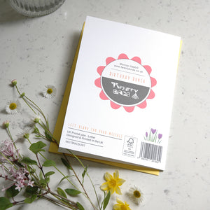 Greeting card with 'Twenty Birds' branding on a light surface with flowers.