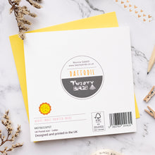 Load image into Gallery viewer, Back of card with twenty birds brand label on a marble surface
