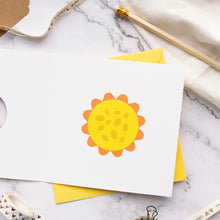 Load image into Gallery viewer, White card with a yellow centre of a daffodil design on a marble surface
