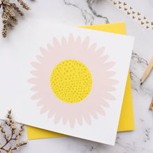 Load image into Gallery viewer, Card with a pink flower design on a yellow envelope against a marble background