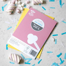 Load image into Gallery viewer, The back of a pink card with a white dog's tail and a circular graphic reading 'FAB POODLE' and 'Twenty Birds' lies on top of a yellow notebook on a light marble surface scattered with blue confetti and pink-and-white marshmallows.