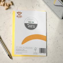 Load image into Gallery viewer, A square white dog card with a yellow envelope, placed on a light marble surface. The card features a circular 'MISS YOU', the 'Nose to toes' brand logo, and a curved orange accent graphic.
