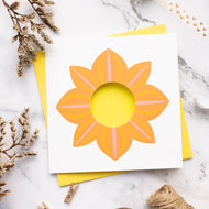 Card with an orange dahlia design on a marble surface
