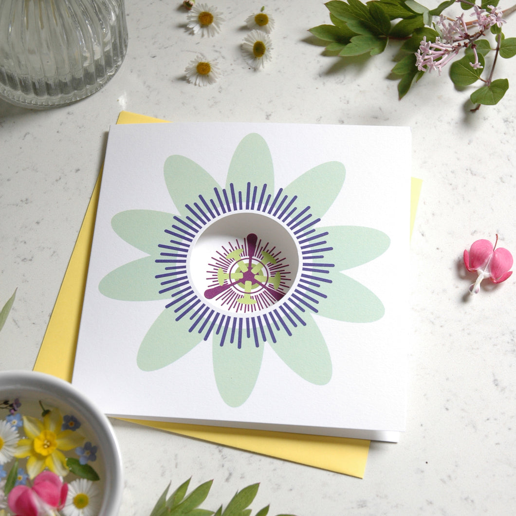 Greetings card with a passion flower on the front. The card has a circle cut out on the front.
