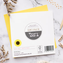 Load image into Gallery viewer, Back of card with twenty Birds branding on a marble surface