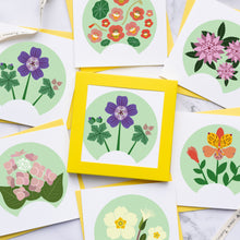 Load image into Gallery viewer, Set of floral cards with colorful flowers on a marble surface