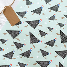 Load image into Gallery viewer, Pattern of black and white geometric guineafowl on a light green background with a brown tag.