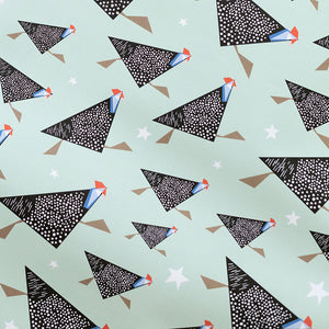 Pattern of guineafowl with black geometric shapes with white dots on a light green background