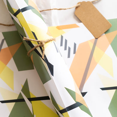 Geometric patterned gift wrap with a brown tag and string