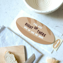 Load image into Gallery viewer, A baguette shaped greetings card on a marble urface surrounded by bread related items such as a bread knife and prooving bowl